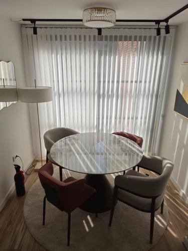 a dining room with a glass table and chairs at Negotin Centar Boutique Residence in Negotin