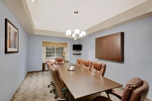 a dining room with a table and leather chairs at Microtel Inn and Suites by Wyndham - Geneva in Geneva