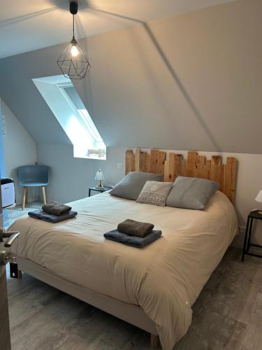 a bedroom with a large bed with two towels on it at Chez Mary Elise in Le Claux