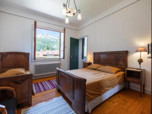 a bedroom with a large bed and a window at maison savoyarde in Doussard