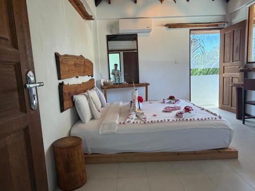 a bedroom with a large bed with a cake on it at Aqua oasis in Thoddoo