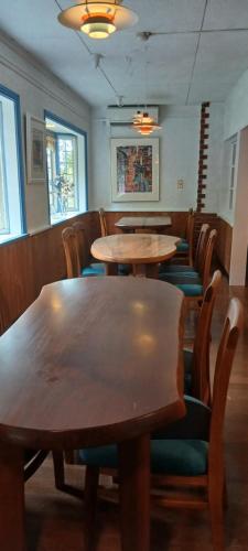 a dining room with wooden tables and chairs at Cafe&ResortInn VAIRGO in Hoki