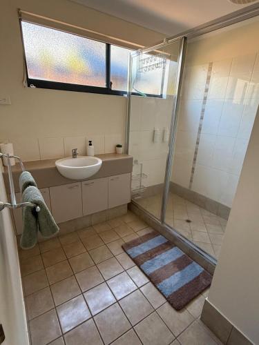 a bathroom with a sink and a shower at Broome Rest House in Broome