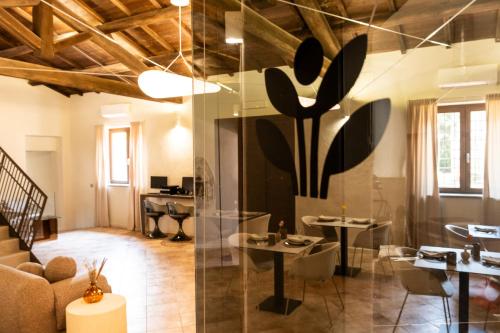 a living room with a glass wall with tables and chairs at Alnus in Valentano