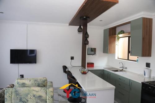 a kitchen with a sink and a counter top at Yolaan Guesthouse in Sterkspruit