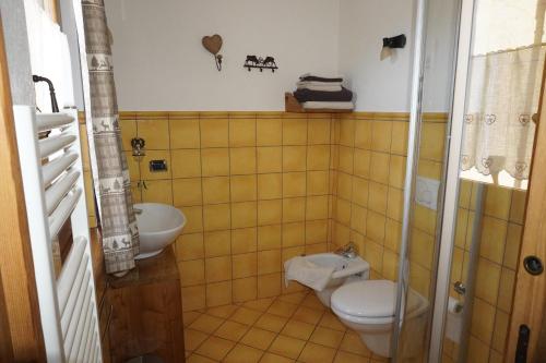 a bathroom with a toilet and a sink at B&B Petit in Sauze dʼOulx