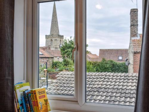 a window with a view of a church at The Swiss Cottage in Pickering