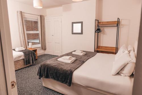 a bedroom with two towels on a bed at STAYtastic in Lowestoft