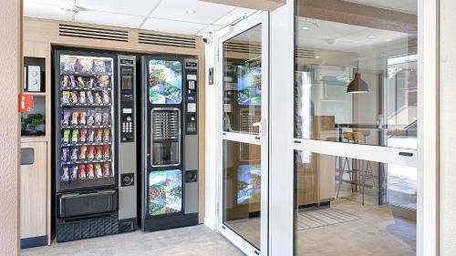 a vending machine in a building with soda cans at Premiere Classe Dreux in Dreux
