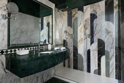 a bathroom with a sink and a mirror at Sina Brufani in Perugia
