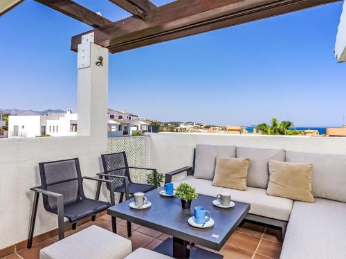 a patio with a couch and chairs and a table at Apartment Alamar by Interhome in La Cala de Mijas