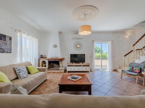 a living room with a couch and a tv at Holiday Home Casa do Sol by Interhome in Patroves