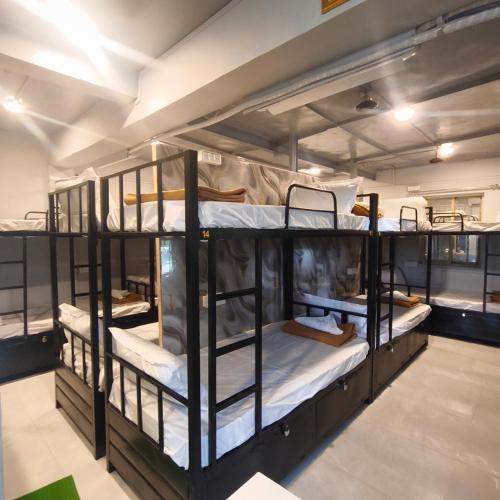a group of bunk beds in a room at Hotel My Home Dormitory in Boisar