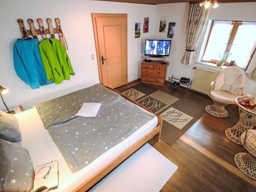 a room with a bed and a tv in it at Apartment FeWo Bärli by Interhome in Bad Bayersoien