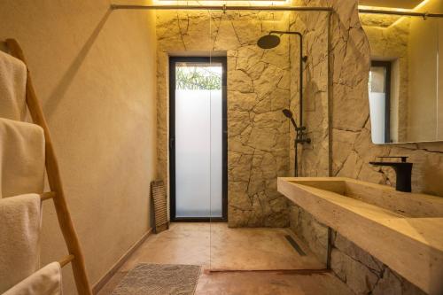 a bathroom with a stone shower and a sink at Palais Nohe in Marrakesh