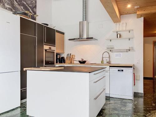 a kitchen with white cabinets and a counter top at Apartment Les Cimes by Interhome in Les Crosets