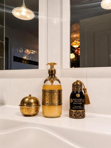 a bottle of alcohol sitting on top of a bathroom sink at Fantastic 6B Villa in Sidi Daoud