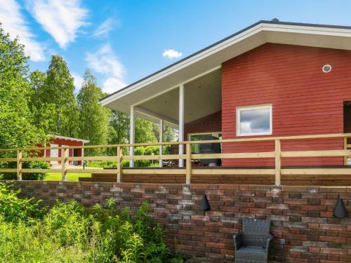 a red house with a large deck at Holiday Home Suvela by Interhome in Kukkola