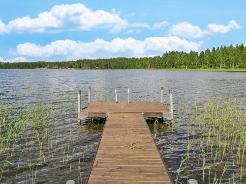 a wooden dock in the middle of a lake at Holiday Home Suvela by Interhome in Kukkola