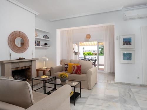 a living room with a couch and a fireplace at Holiday Home Sol de Estepona by Interhome in Estepona