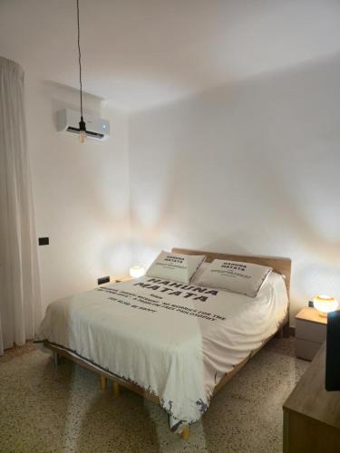 a bed in a room with two boxes on it at HAKUNA MATATA Elegant Apartment in Central Taranto in Taranto