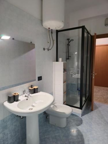 a bathroom with a sink and a toilet at HAKUNA MATATA Elegant Apartment in Central Taranto in Taranto