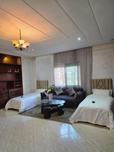 a living room with two beds and a couch at Morocco AG in Casablanca