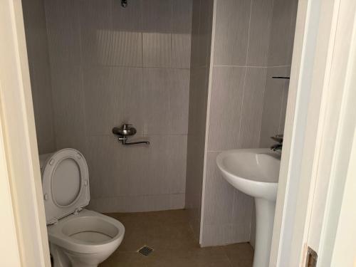 a bathroom with a toilet and a sink at LizAna in Shekhvetili