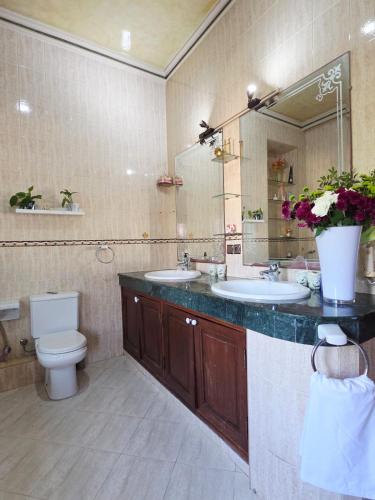 a bathroom with two sinks and a toilet and a mirror at Morocco AG in Casablanca
