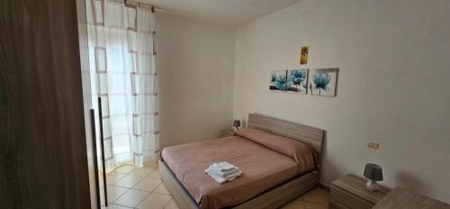 a small bedroom with a bed and a window at Petrucci House in Vasto