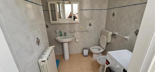 a bathroom with a sink and a toilet and a mirror at Petrucci House in Vasto