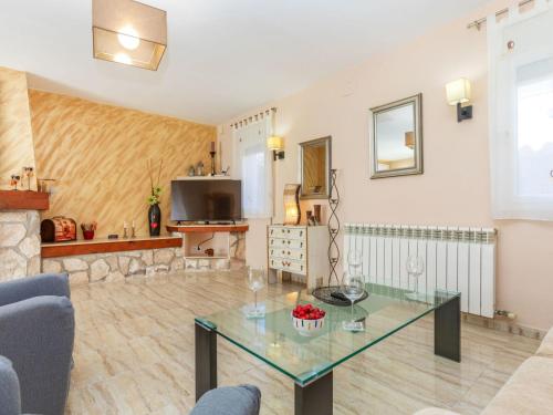 a living room with a glass table and a tv at Villa Villa Cantos by Interhome in L'Ametlla de Mar