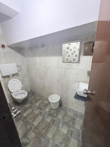 a bathroom with a toilet and a bidet at Hotel keshav in Ahmedabad