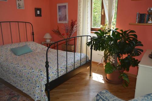 a bedroom with a bed and plants in it at Casa del Zefiro in Sistiana