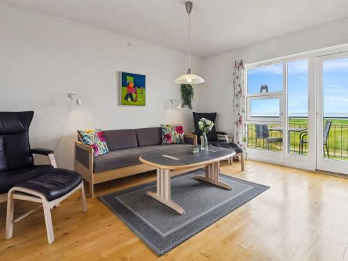 a living room with a couch and a table at Apartment Sofija by Interhome in Højer