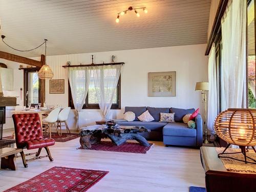 a living room with a blue couch and a table at Holiday Home Dorenavant by Interhome in Bouveret