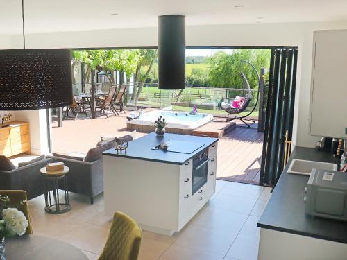 a kitchen and living room with a view of a patio at Deerview Lodge - Uk51044 in Bonvilston