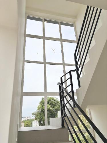 a staircase leading up to a large window at Meadows Homestay Elite in Madurai