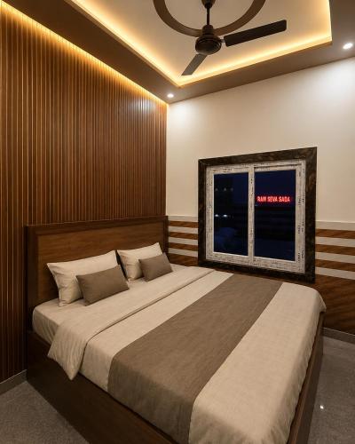 a bedroom with a large bed and a window at Priya Dham in Govardhan