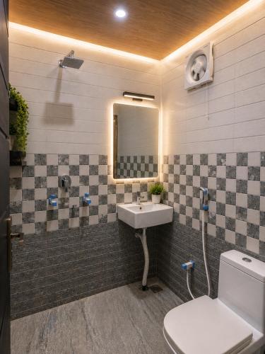 a bathroom with a sink and a mirror at Priya Dham in Govardhan