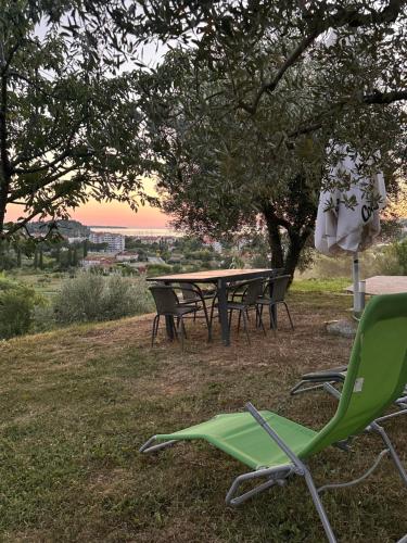 a picnic table and chairs under a tree at Residence Villa Fiore Portorož in Portorož