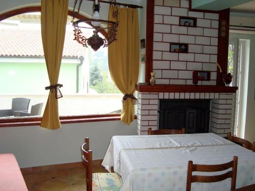 a bedroom with a bed and a fireplace and a window at Apartman Marija Krok in Baška