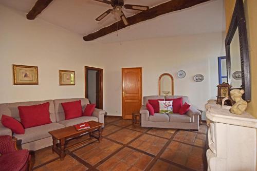 a living room with two couches and a table at Domaine Saint Ferreol in Nizas