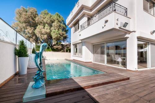 a swimming pool in the middle of a house at Cosytal Villa in Herzliya