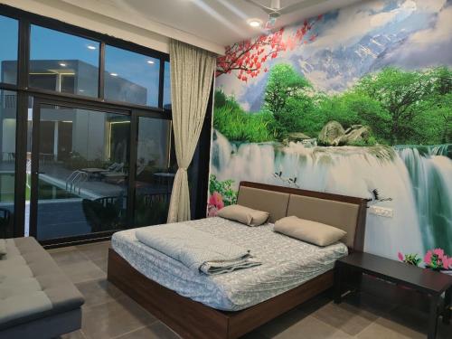 a bedroom with a bed with a painting on the wall at Achala Resorts in Maisaram