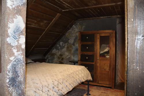 a bedroom with a bed and a wooden cabinet at Villa LEA in Ratkovské Bystré
