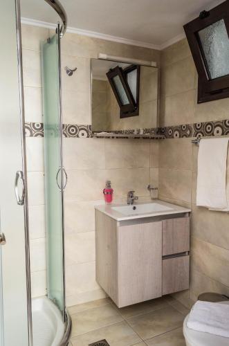 a bathroom with a sink and a shower at Villa Soultana in Lindos