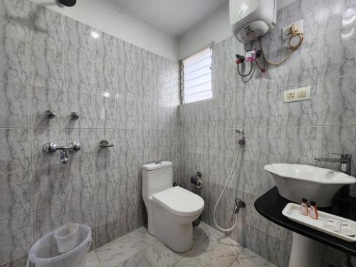 a bathroom with a toilet and a sink at Hotel Housez 43 in Kolkata