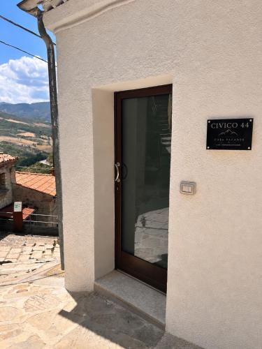 a door to a building with a sign on it at Civico 44 in Castelmezzano