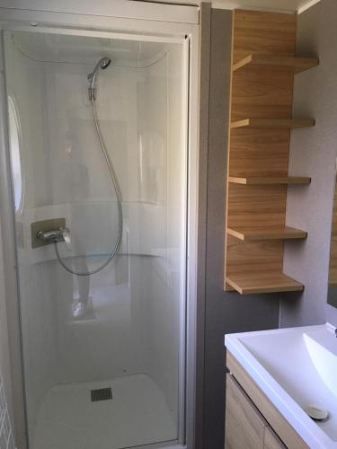 a shower in a bathroom with a sink at Camping Familial Buffalo Hacienda in La Seyne-sur-Mer